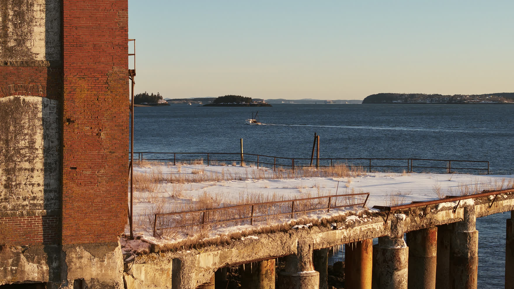 The historic American Can building, a long brick factory standing on pilings over Passamaquoddy Bay in Eastport, Maine.